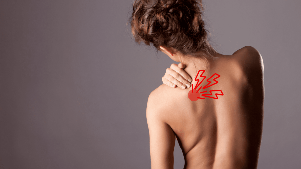 A Woman Grabbing at her Shoulder with Should Blade Knot Pain