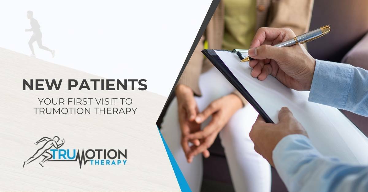 Man writing on clip board in front of anticipatory woman. New patients. Your first visit to TruMotion Therapy.